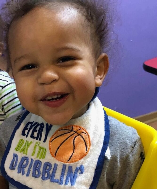Smiling Baby in High Chair